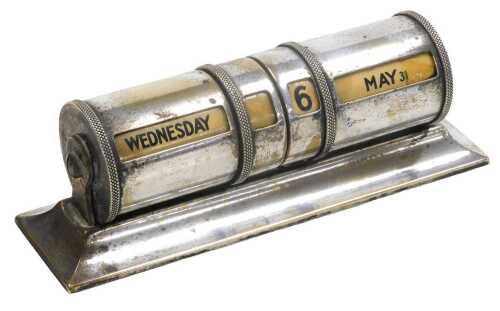 An early 20thC silver plated perpetual desk calendar, of cylindrical form, on an outswept...