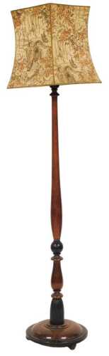 An late Victorian and ebonised standard lamp, with a turned column, and fabric shade, decorated...