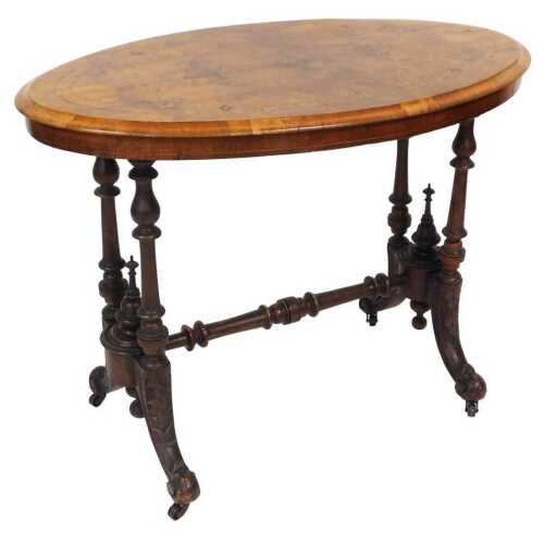 A Victorian walnut and inlaid occasional table, with an oval top, raised on turned supports and...