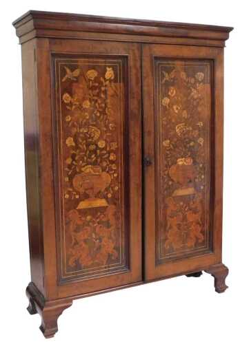 A 19thC mahogany and marquetry cupboard, the arched shaped pediment above a pair of doors with...