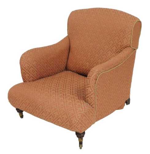 A late Victorian mahogany armchair, by Howard & Sons, of London, upholstered in red draylon with...