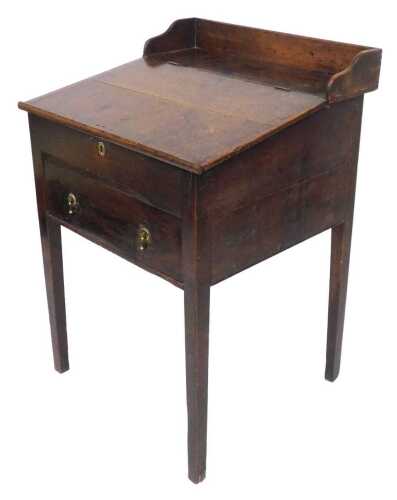 An early 19thC Georgian oak clerk's desk, with a three sided galleried back, and slope, opening...