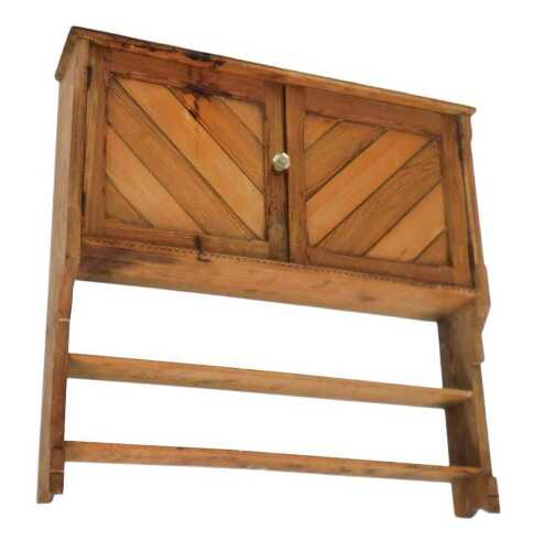 A Victorian pine hanging wall shelf, with three shelves, above a pair of cupboard doors...
