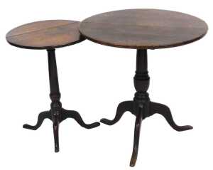 A George III oak tilt top occasional table, the circular top raised on a turned column over...
