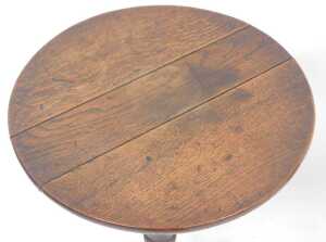 A George III oak tilt top occasional table, the circular top raised on a turned column over... - 2