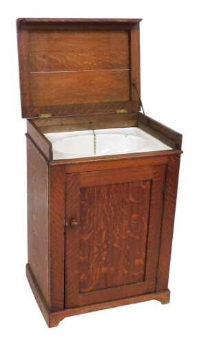 Reds (1981) movie interest, a late/early 20thC oak enclosed washstand, the hinged lid revealing...