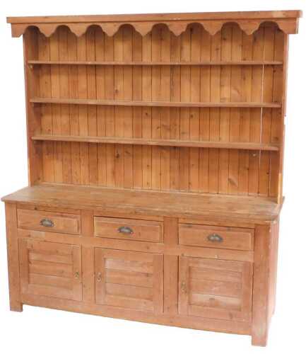 A 19thC and later pine dresser, the associated top with three shelves, the base with a planked...
