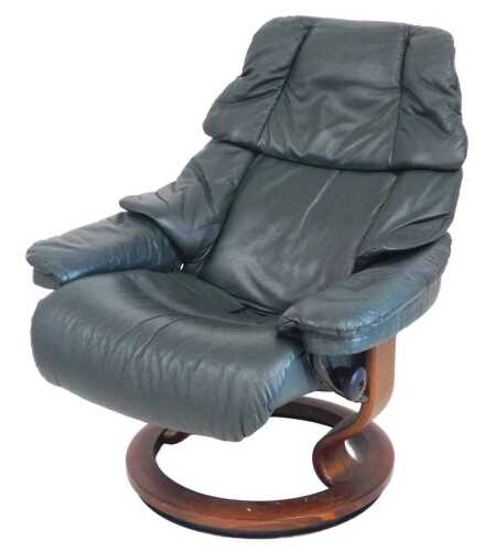 A Stressless green leather adjustable armchair, on a circular base.
