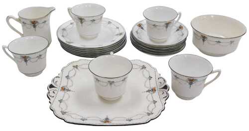 A Shelley part tea service, decorated with a stylised basket of flowers, scrolls, leaf swags,...