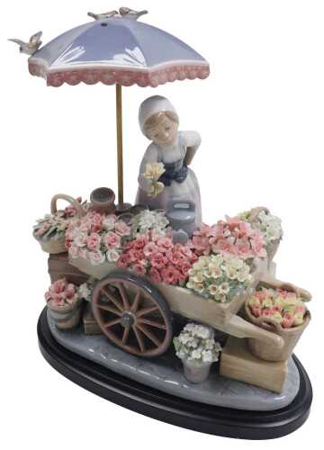 A Lladro porcelain figure Flowers of the Season, modelled in the form of a flower seller with...