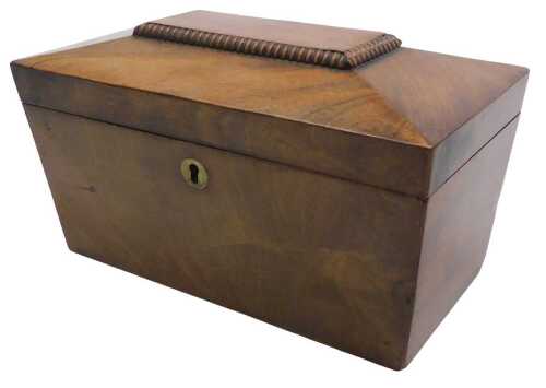 An early Victorian mahogany sarcophagus shaped tea caddy, the gadrooned hinged tapering lid...