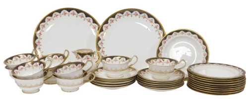 An early 20thC Wedgwood porcelain part tea service, decorated with roses within a cobalt blue...