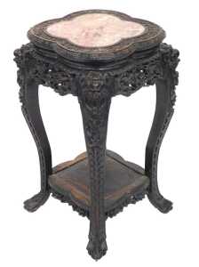 A late 19thC Chinese hardwood urn stand, the carved quatrelobe top inset with red and white...