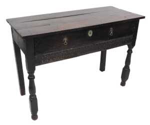 A 17thC oak serving table, with a triple plank top, above one long drawer over a frieze carved...