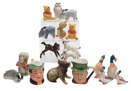A group of Beswick and other figures, including a pair of seated Winnie the Poohs, Beswick...