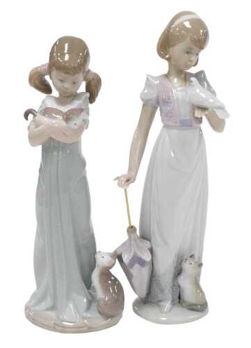 A Lladro porcelain figure of a girl with a cat and kitten, number 5743, and a further figure of...
