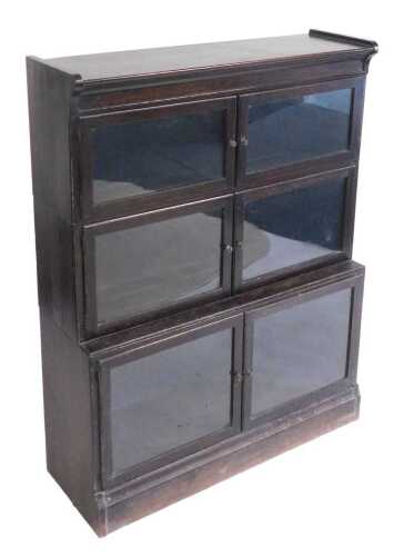 A Victorian Globe Wernicke style oak bookcase, the upper section with four glazed doors...