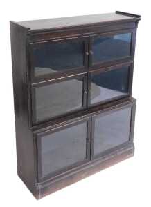 A Victorian Globe Wernicke style oak bookcase, the upper section with four glazed doors...