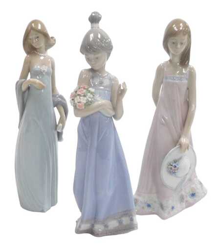 A Lladro porcelain figure of a girl with a bonnet, number 5547, another of a girl with a bouquet...