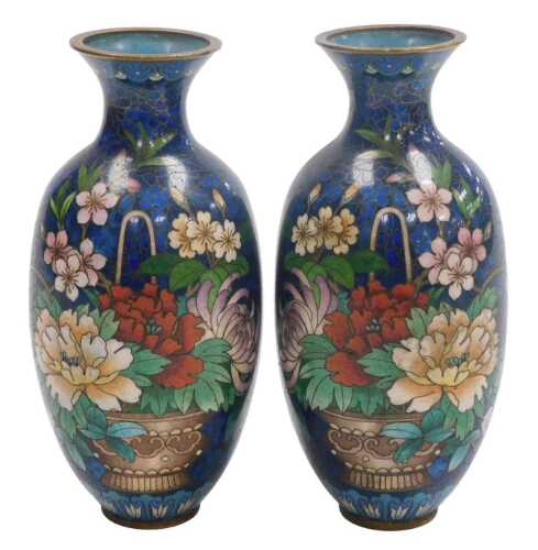 A pair of late 20thC Chinese blue cloisonne vases, decorated with flowers in a vase, bears paper...