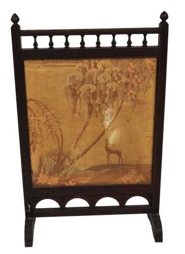 A Victorian mahogany framed fire screen, set with a silk panel, decorated with a deer in a...
