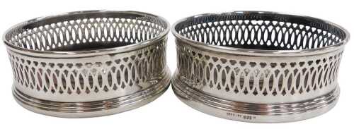 A pair of silver and turned wooden coasters, with a pierced gallery, stamped sterling, 8.98oz...