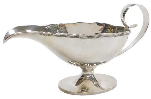 A Swiss Fontaine sauce boat, with a gadrooned rim, and scroll handle, on an oval outswept foot,...
