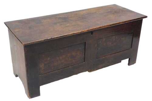 An 18thC oak coffer, with a two plank top, above a plain panelled frieze, raised on stiles, 54cm...