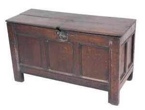 An 17thC oak coffer, with a two plank top, above a triple panelled front, raised on stiles, 65cm...