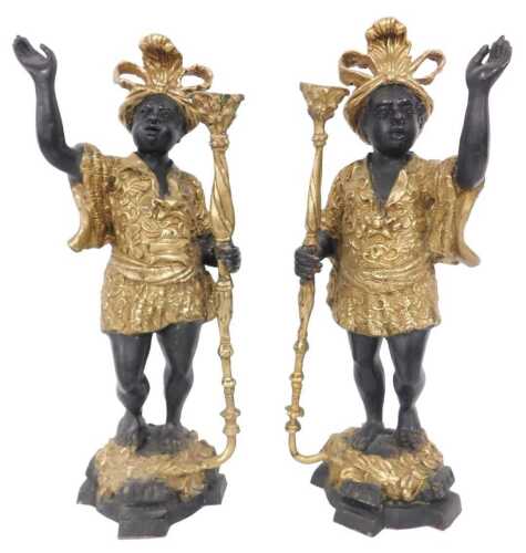 A pair of cast bronze Blackamoor torcheres, modelled in standing pose with an ornate hat and...