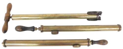 A Shelley brass and iron foot pump, with a turned wooden handle, (AF), and two brass garden...