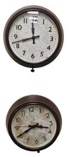 Two Smiths electric factory clocks, each in a brown Bakelite case, 28cm diameter.