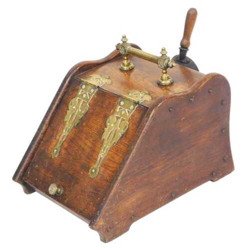 A Victorian oak coal scuttle, with brass strapwork and carrying handle, the hinged lid opening...