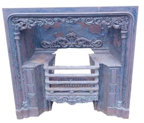 An early 19thC cast iron fire insert, with grate, embellished with scrolls, leaves, pillars, etc....