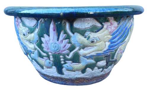 A large Chinese green glazed jardiniere, decorated with a multicoloured dragon, 37cm high, 71cm...