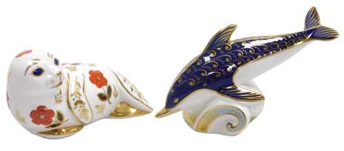 A Royal Crown Derby porcelain figure of a dolphin, riding the crest of a wave, silver stopper,...