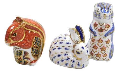 Three Royal Crown Derby porcelain paperweights, comprising a chipmunk, red squirrel, gold...