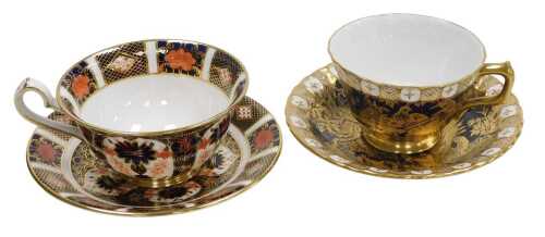 A Royal Crown Derby porcelain Imari tea cup and saucer, pattern no. 1128, together with a Royal...