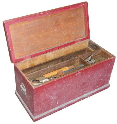 A red painted pine tool chest, containing a number to tools to include saws, spoke shaves, etc.,...