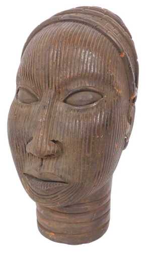 A Benin tribal terracotta female bust, with stylised striped decoration to face, and cylindrical...