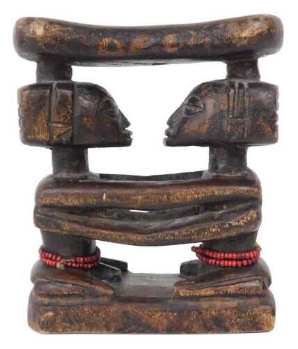 An African Luba Shankadi carved head rest, in the form of two figures, 13cm high, 12cm wide.