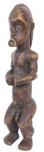 An African Fang carved tribal male figure, in the standing position, 62cm high.