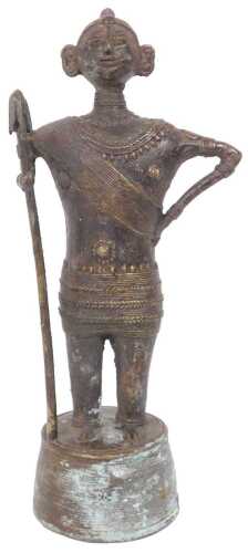 An Indian bronze figure of a warrior, possibly Dhokra, on a tapering base, 26cm high.