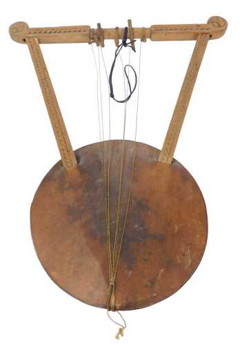 An Ethiopian hardwood kraar, the frame with a carved border, 62cm high.