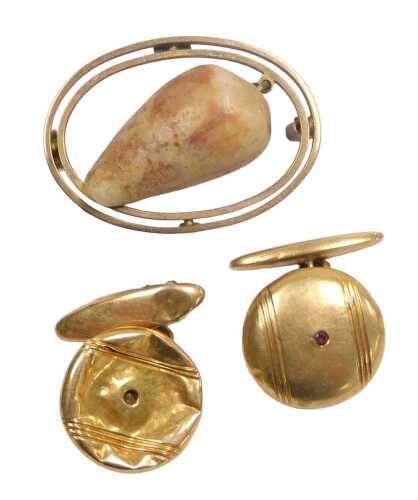 A shell brooch, in a double oval wire open frame, yellow metal, stamped 9ct, 3.4g all in,...