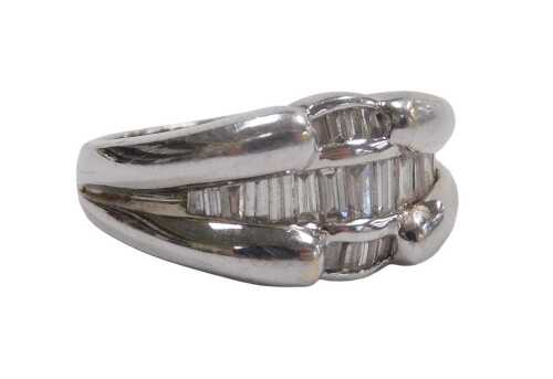 An 18ct white gold and diamond ring, channel set with baguette cut diamonds, size M 1/2, 7.3g.