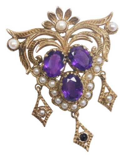 A 9ct gold amethyst and seed pearl brooch, of floral and foliate form, with three tassel drops,...