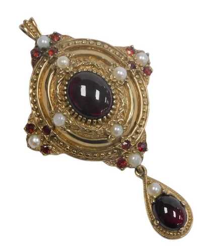 A Victorian style 9ct gold garnet and seed pearl pendant brooch, of oval form, with a tear...