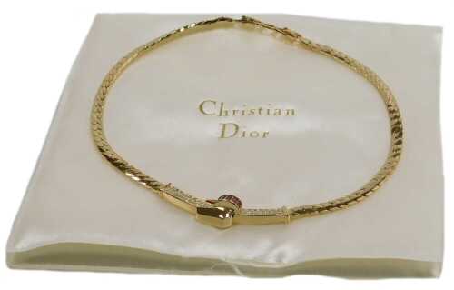 A Christian Dior gold plated necklace, with red baguette and white paste stones set in a belt...