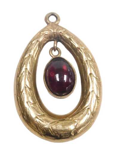 A 9ct gold and garnet pendant, the cabochon garnet suspended within a laurel wreath frame, 3.2g.